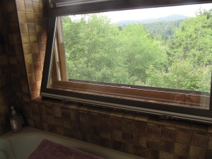 The window in the bathroom in its upside down position supported by the wide sill.